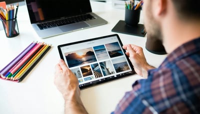 Graphic designer reviewing a creative portfolio on a digital tablet Graphic designer reviewing a creative portfolio on a digital tablet